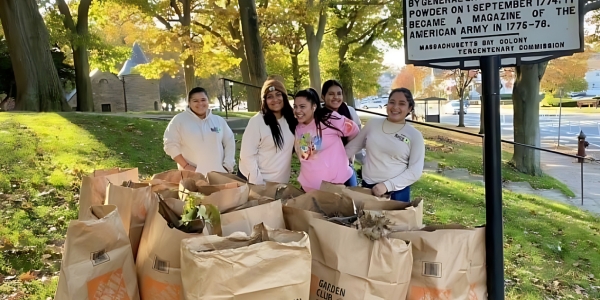 Anyi poses with her Transitional Employment crew after a work shift cleaning up a local park.